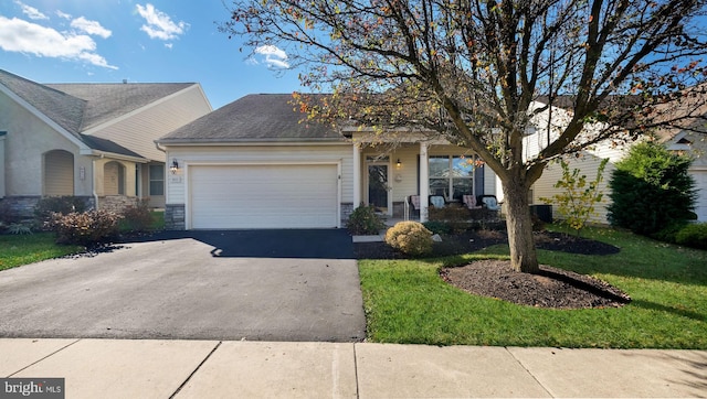 view of front of home with a garage and a front yard