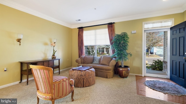 living room with ornamental molding and light hardwood / wood-style floors