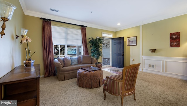 living room with light colored carpet and ornamental molding