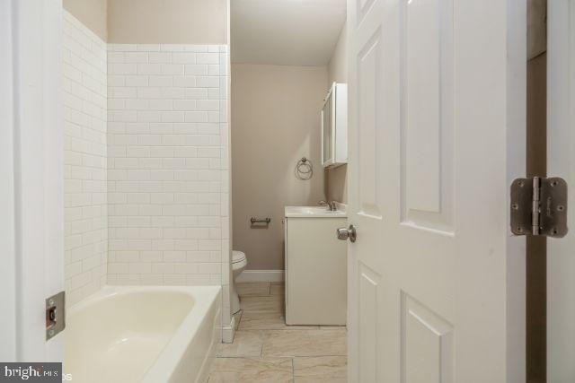 bathroom featuring toilet and vanity