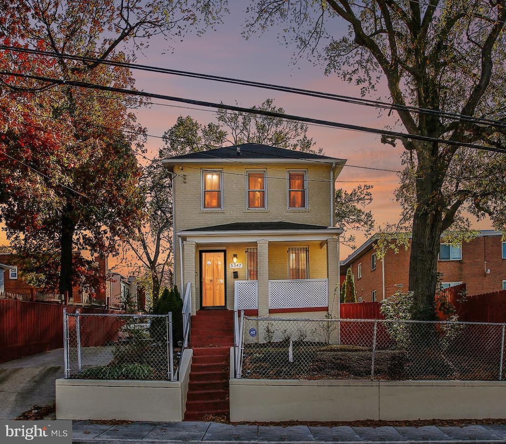 5347 Bass Pl SE, Washington, DC 20019 - traditional style home featuring covered porch and a fenced front yard
