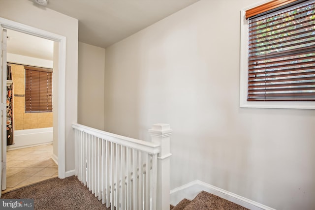 hallway with tile patterned flooring