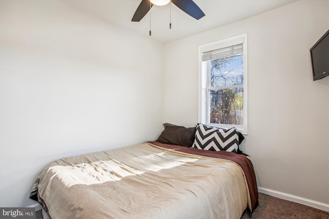 bedroom featuring ceiling fan and dark colored carpet