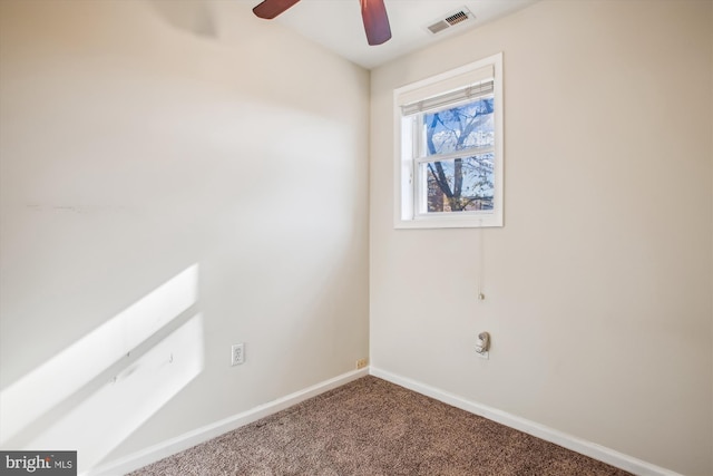 carpeted spare room featuring ceiling fan