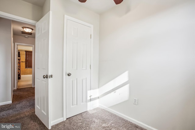 hallway with dark colored carpet