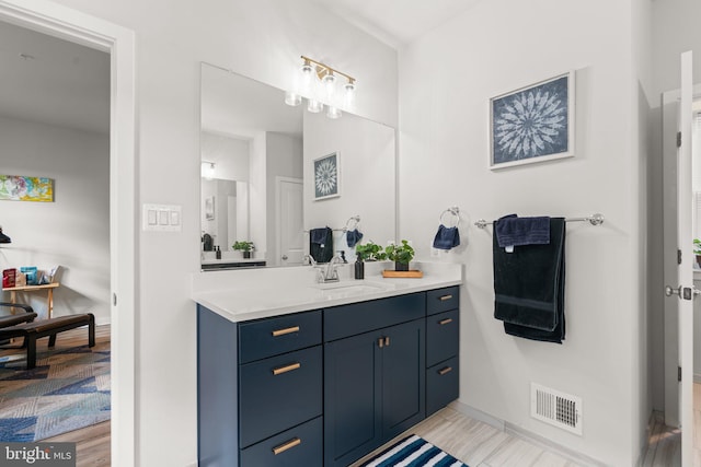 bathroom with hardwood / wood-style flooring and vanity