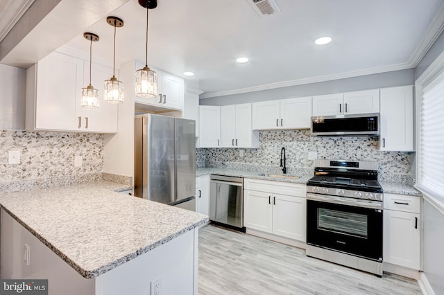 kitchen with crown molding, white cabinetry, sink, and appliances with stainless steel finishes