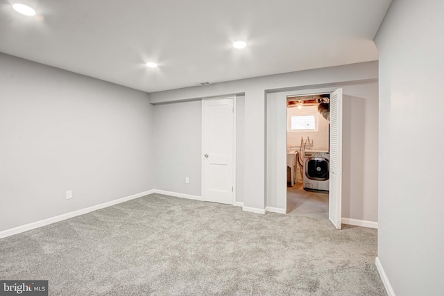 interior space with washing machine and dryer and light carpet