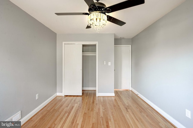 unfurnished bedroom with ceiling fan, a closet, and light hardwood / wood-style floors