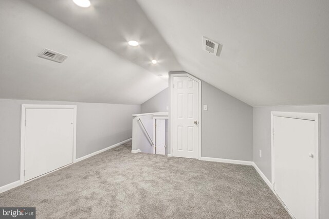 bonus room with carpet and lofted ceiling