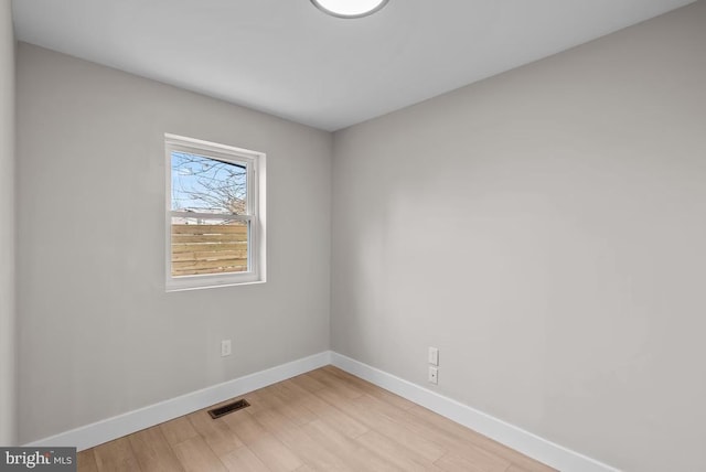 spare room with light hardwood / wood-style flooring