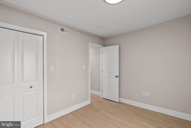 910 N Markoe St, Philadelphia, PA 19131 - unfurnished bedroom featuring wood finished floors, baseboards, and a closet