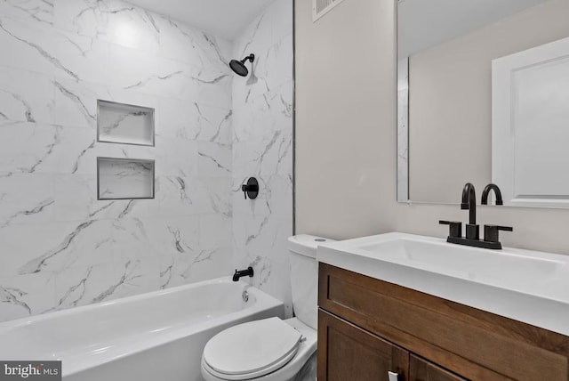 full bathroom featuring vanity, toilet, and tiled shower / bath