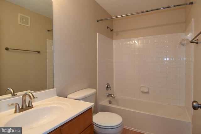 full bathroom with vanity, toilet, and tiled shower / bath