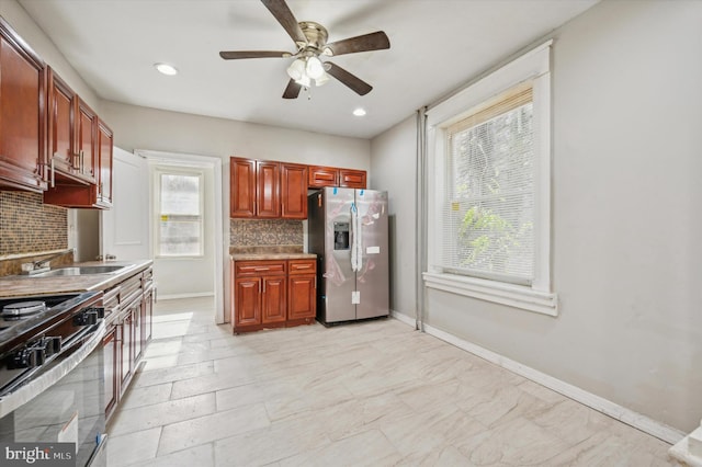 kitchen featuring stainless steel appliances, tasteful backsplash, a healthy amount of sunlight, and ceiling fan