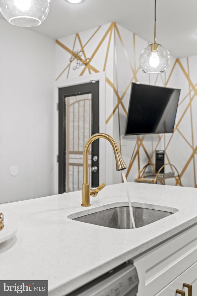 6127 Lebanon Ave, Philadelphia, PA 19151 - kitchen with a sink, dishwashing machine, pendant lighting, and white cabinetry