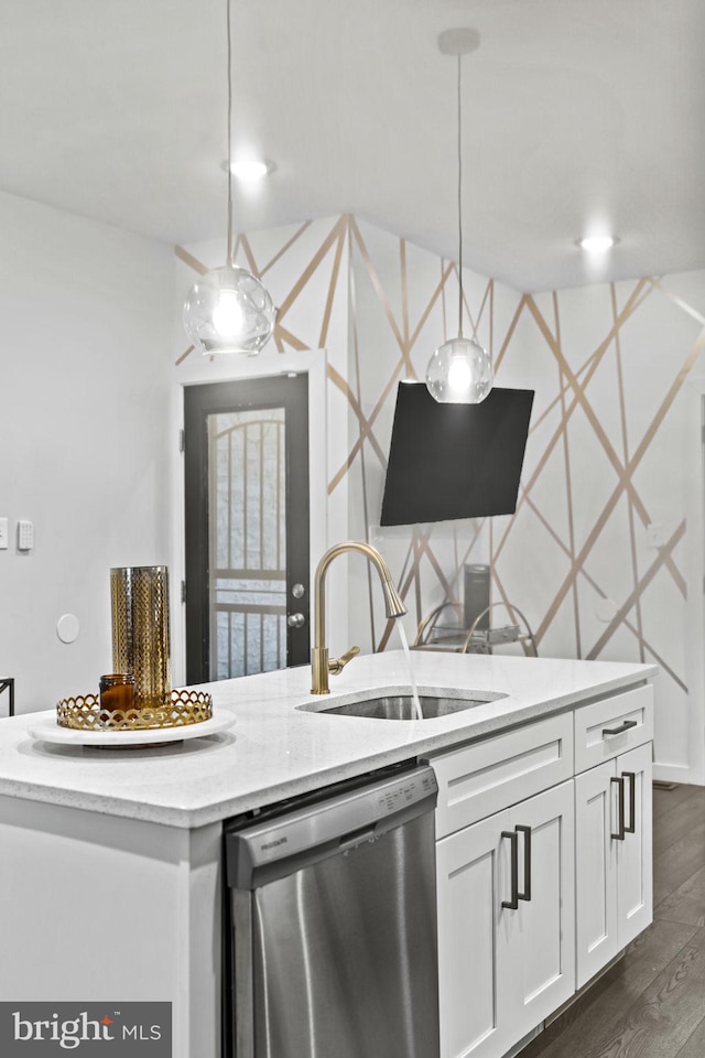 kitchen featuring dishwasher, sink, dark hardwood / wood-style flooring, pendant lighting, and white cabinets