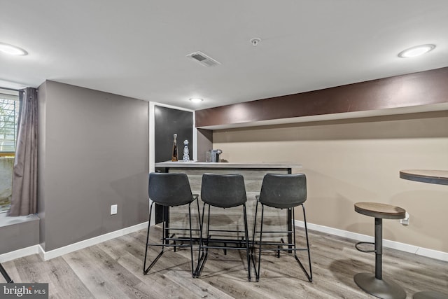 bar featuring light wood-type flooring