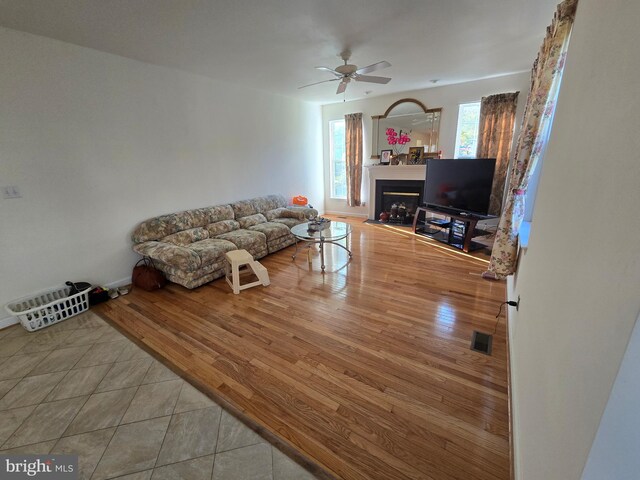 living room featuring ceiling fan and hardwood / wood-style flooring