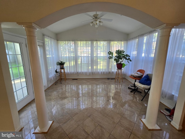 unfurnished sunroom featuring ceiling fan, lofted ceiling, a wealth of natural light, and decorative columns