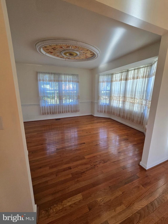 unfurnished room with hardwood / wood-style flooring