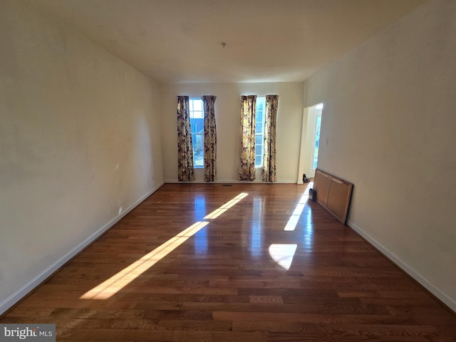 spare room with dark hardwood / wood-style floors