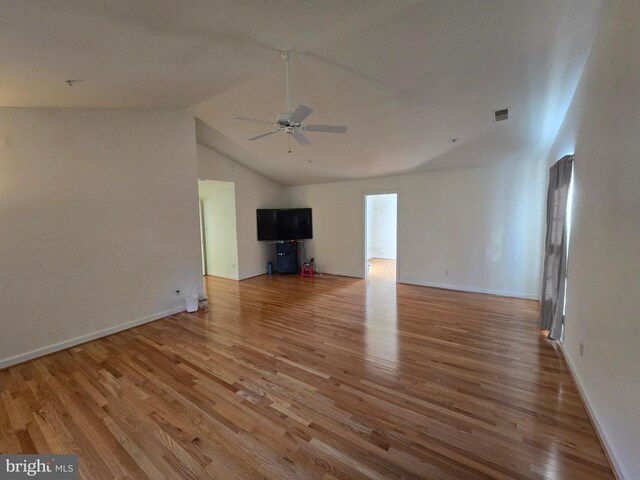 unfurnished living room featuring hardwood / wood-style floors, ceiling fan, and lofted ceiling