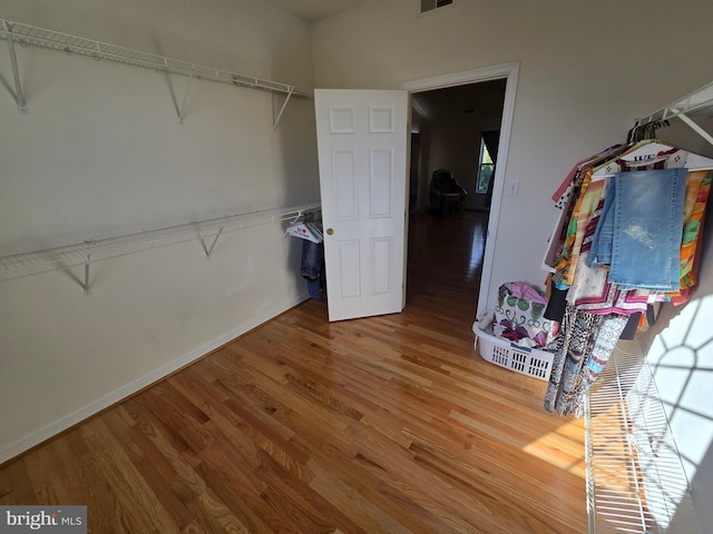 spacious closet with hardwood / wood-style flooring