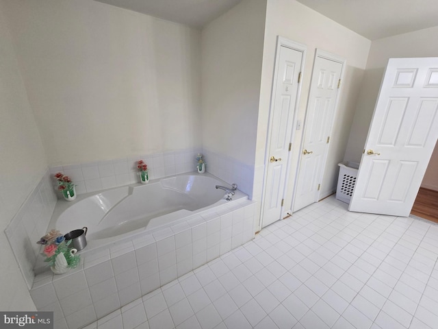 bathroom featuring tile patterned floors and tiled tub