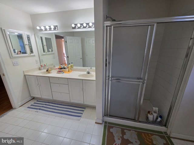 bathroom featuring tile patterned flooring, vanity, and a shower with shower door