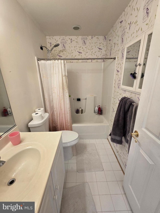 full bathroom featuring toilet, shower / bath combo with shower curtain, vanity, and tile patterned flooring