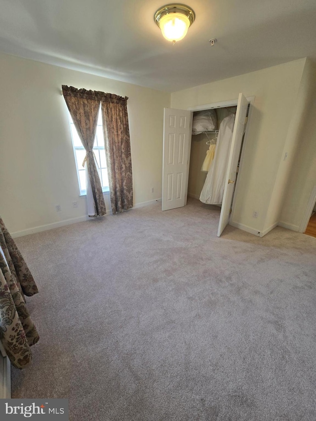 unfurnished bedroom with a closet and carpet