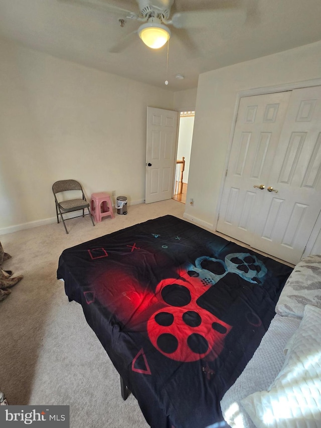 carpeted bedroom featuring a closet and ceiling fan