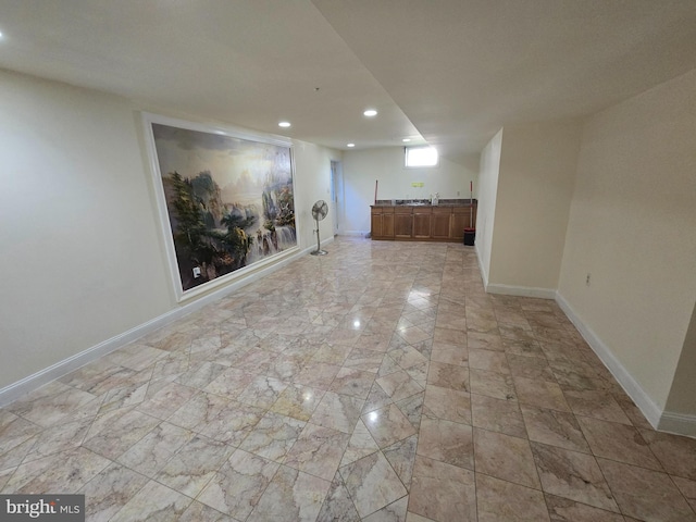 unfurnished room with indoor bar