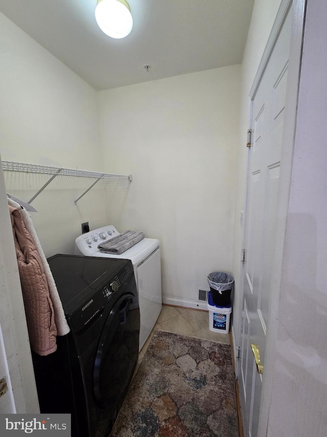 laundry room with washing machine and clothes dryer