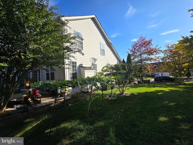 view of property exterior with a lawn