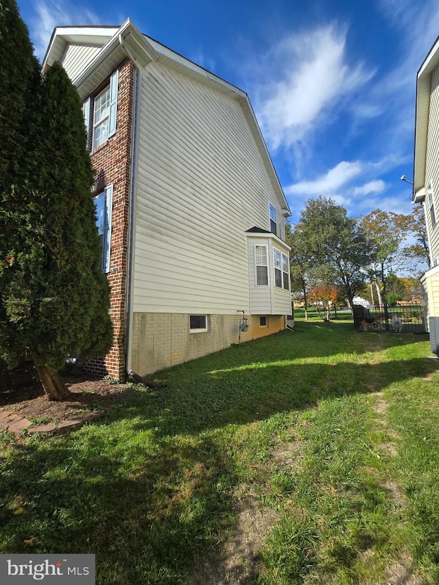 view of property exterior featuring a lawn