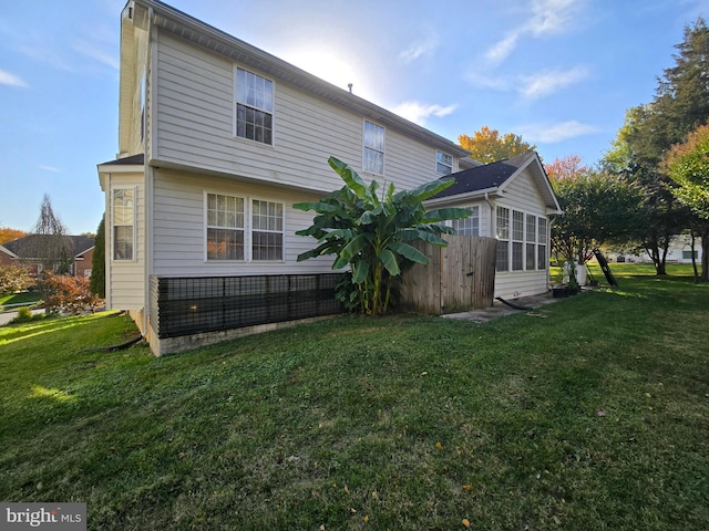 back of house with a lawn