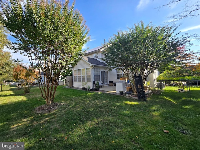 view of yard with central AC unit, a sunroom, and a patio