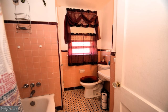 full bathroom featuring shower / tub combo, a wainscoted wall, tile walls, and toilet