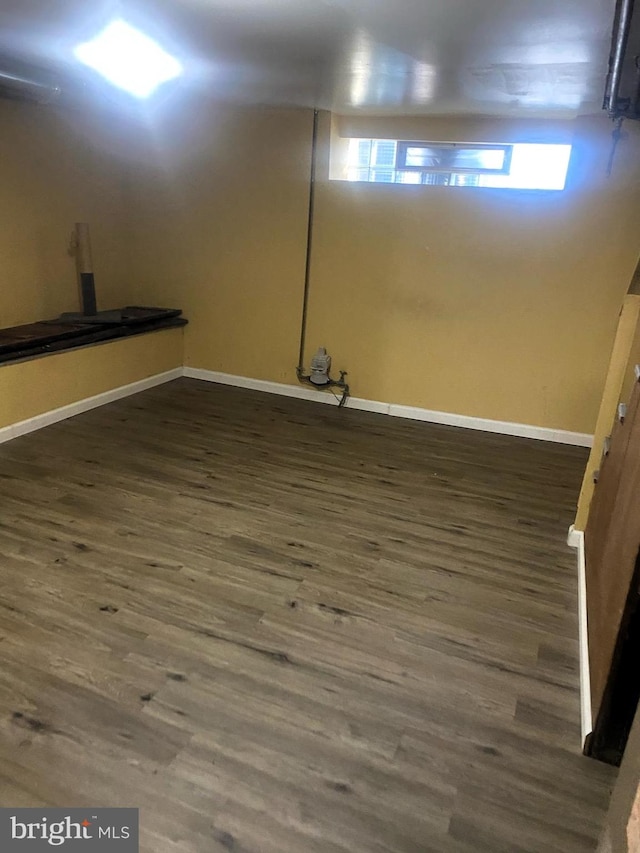 basement with dark wood-style floors and baseboards