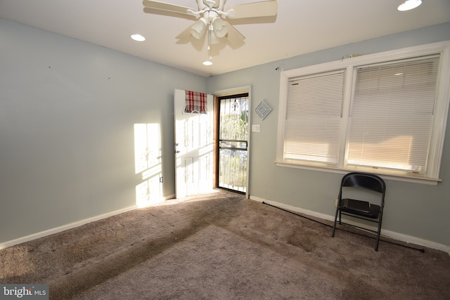 spare room featuring recessed lighting, dark carpet, a ceiling fan, and baseboards