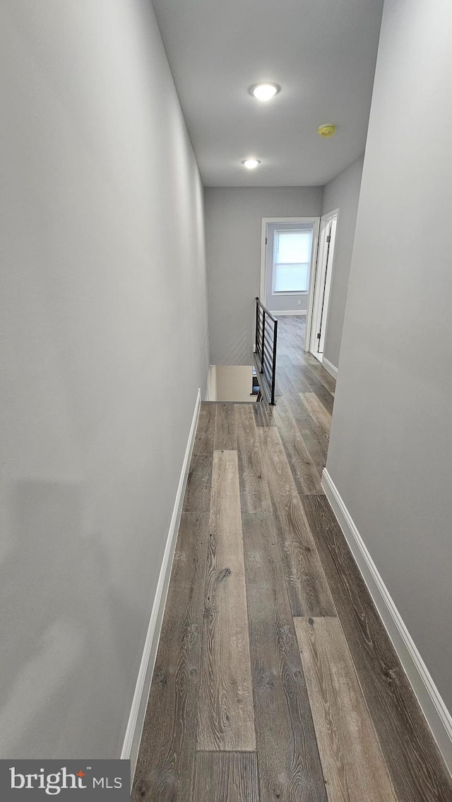 hallway with hardwood / wood-style floors