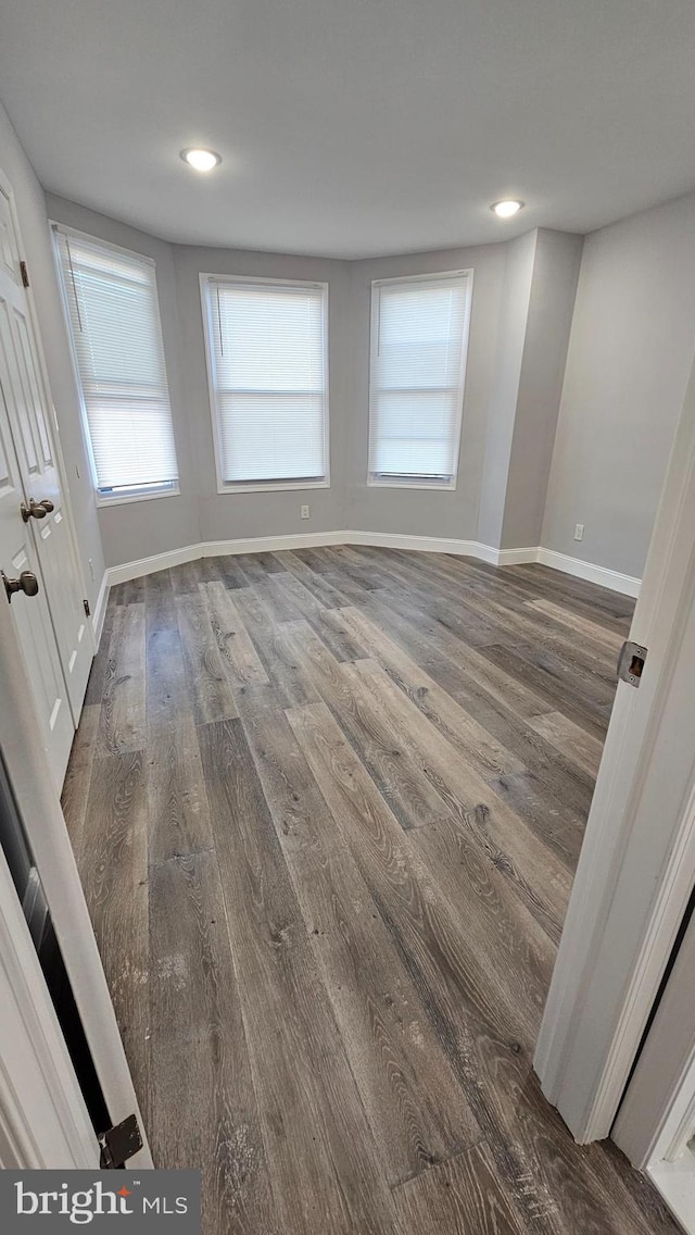 spare room with dark hardwood / wood-style floors