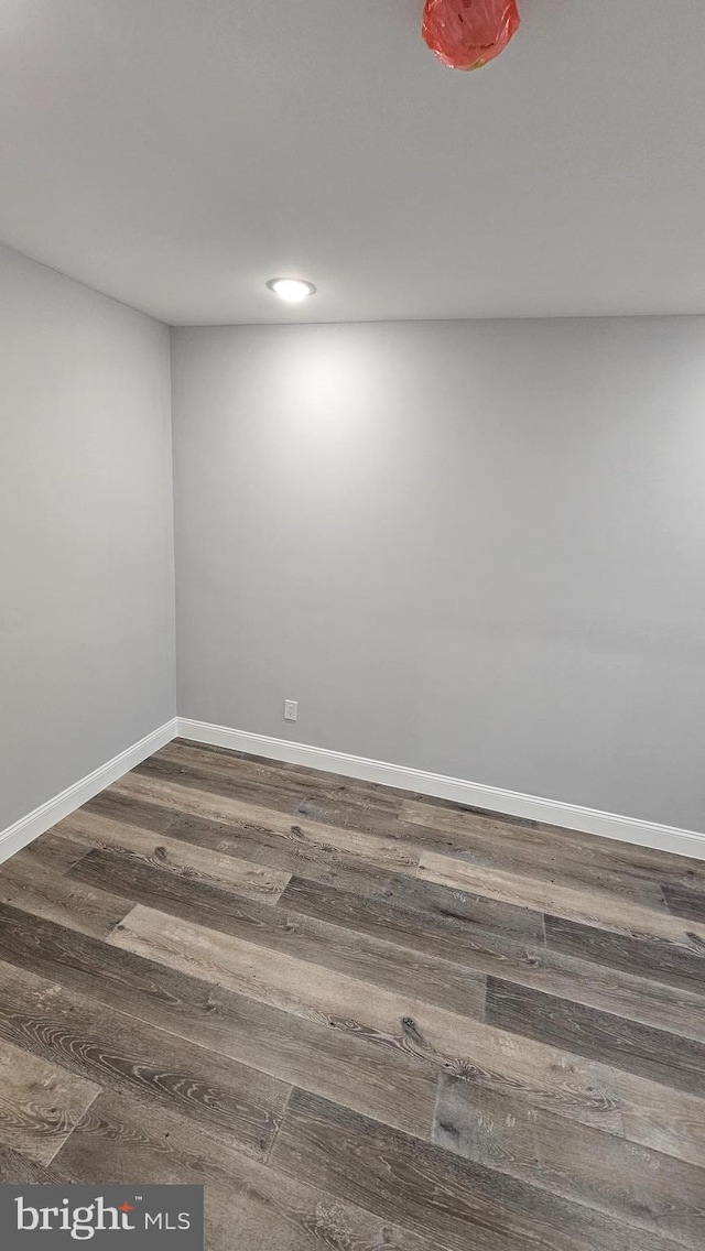 spare room with dark wood-type flooring