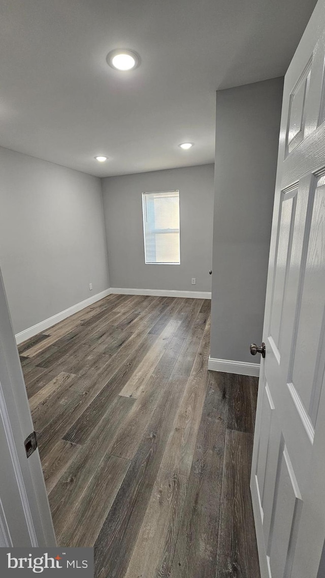 spare room with dark hardwood / wood-style floors