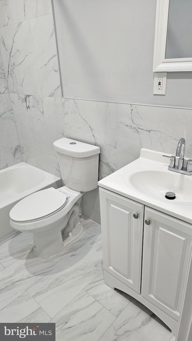 full bathroom with vanity, toilet, tile walls, and bathing tub / shower combination