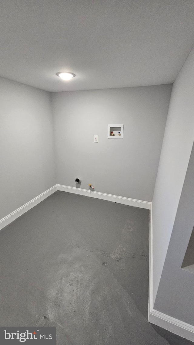 laundry area with hookup for a washing machine, a textured ceiling, carpet flooring, and hookup for a gas dryer