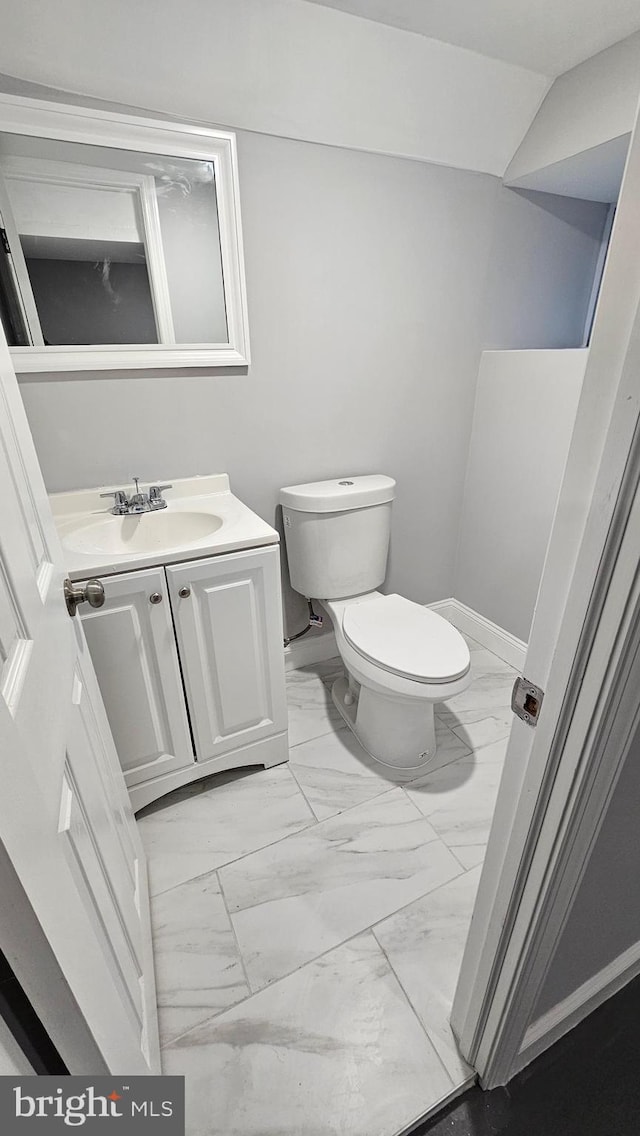 bathroom featuring toilet and vanity