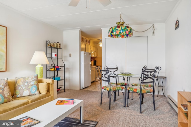 carpeted dining room featuring baseboard heating